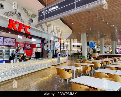 Mumbai, India - October 22, 2025: KFC restaurant located in Chhatrapati Shivaji International Airport featuring a dining area and directional signage Stock Photo