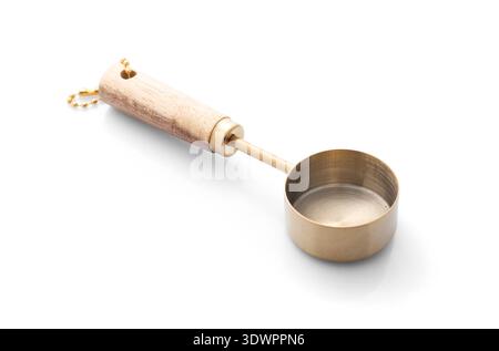 One golden scoop isolated on white. Kitchen utensil Stock Photo