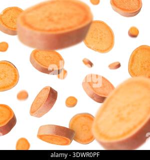 Sweet potato pieces falling against white background Stock Photo