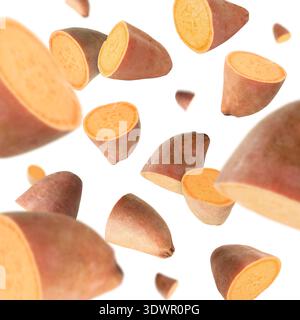 Sweet potato pieces falling against white background Stock Photo