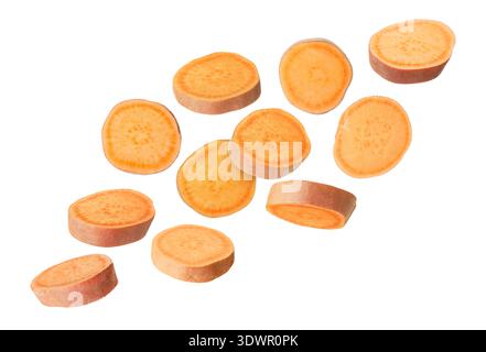 Sweet potato pieces falling against white background Stock Photo