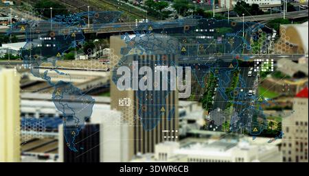 Displaying digital world map overlay over downtown business district, covering high-rise buildings Stock Photo