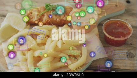 Showing pile of fries with fried fish, lemon wedge and sauces on wooden board, featuring overlays Stock Photo