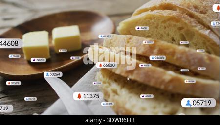 Showing rustic sliced loaf on wood table in kitchen, with butter pats, plate, linen, labels, cursor Stock Photo