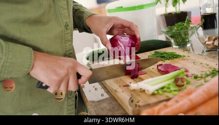 Slicing olive-shirted woman cutting red onion on board at home counter, chef knife and emojis Stock Photo