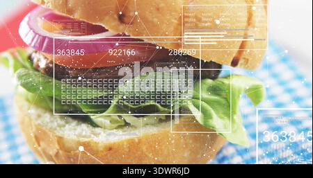 Displaying stacked burger on blue-white gingham cloth, showing HUD overlays and numeric readouts Stock Photo