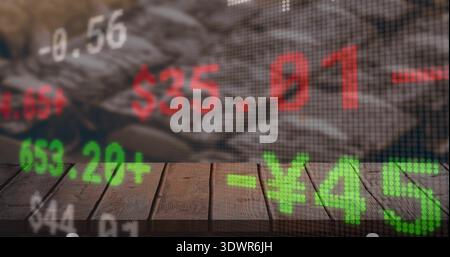 Displaying dotted LED stock ticker overlay on wooden tabletop, showing green Â¥ and red $ numerals Stock Photo