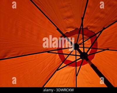 Inside view of outdoor sun umbrella backlit by sunlight Stock Photo