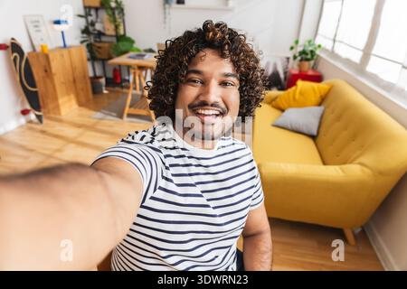 Young Indian man taking selfie portrait home studio Stock Photo