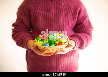 Close up of colorful Easter eggs in a basket Stock Photo