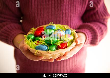 Close up of colorful Easter eggs in a basket Stock Photo