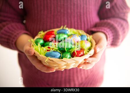 Basket with chocolate colored eggs Easter decor Stock Photo