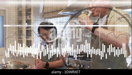 Preparing senior woman and tasting mature man wearing aprons at home, using sink and data overlays Stock Photo