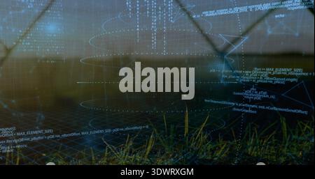 Displaying translucent digital overlay on grassy ground at dusk, showing wireframe grid and rings Stock Photo