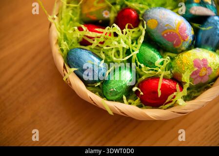 Basket with chocolate colored eggs Easter decor Stock Photo