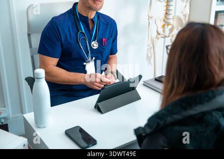 Doctor consulting patient about health using digital tablet Stock Photo