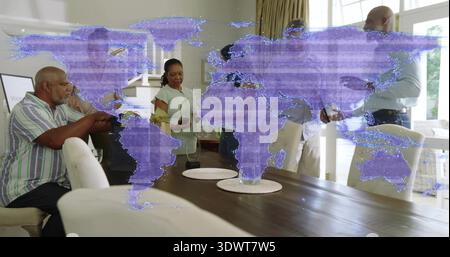 Gathering family standing around long dining table at home, holding smartphones, purple overlay Stock Photo