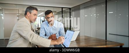 Two busy business men investors doing financial trading market data analysis. Stock Photo