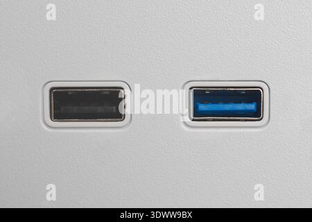 black and blue usb type-a ports in white pc casing, usb 2.0 and 3.0 connectors in textured minimalist surface, top view with copy space Stock Photo