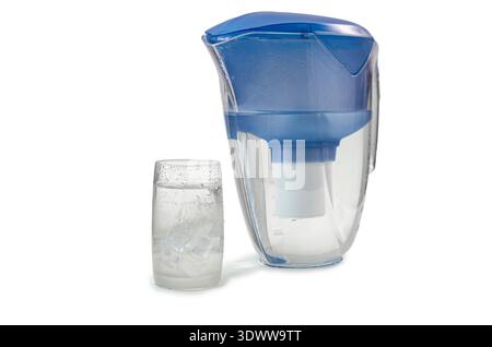 A blue plastic water filtration jug stands next to a clear glass filled with fresh water and ice cubes. The composition is isolated on a white backgro Stock Photo