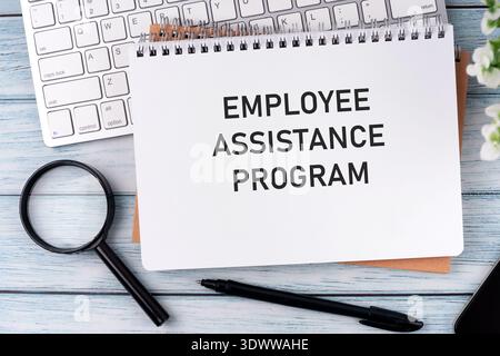Directly above view of employee Assistance Program text on notepad, business text concept Stock Photo