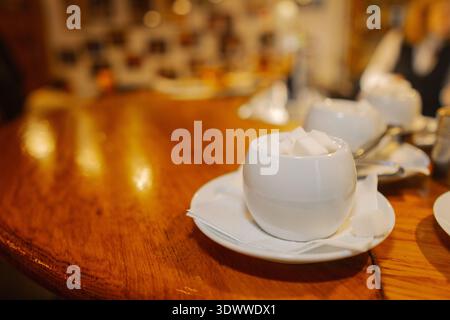 The sugar bowl stands on a wooden table Stock Photo