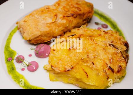 Chicken cutlets sprinkled with almonds on a white plate Stock Photo