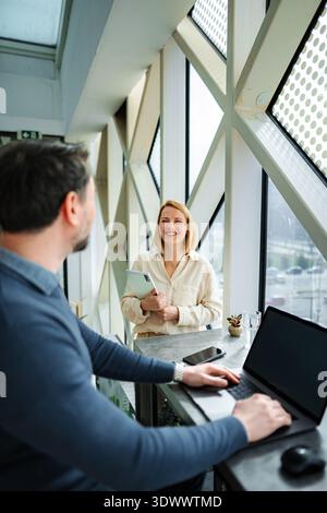 Colleagues collaborating during business meeting in modern office Stock Photo