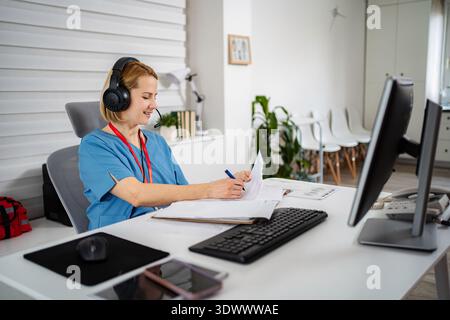 Healthcare worker using headset providing telemedicine services Stock Photo