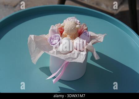 Pastel handmade soap flowers bouquet in white gift box with pink ribbon on turquoise tray.Menton,France Stock Photo