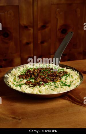 Pinzgauer Kasnockn Austrian Cheese Dumplings with Fried Onion and Chives Stock Photo