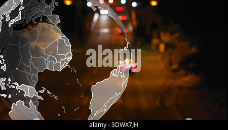 Displaying translucent globe showing continent outlines over blurred city street, with bokeh lights Stock Photo