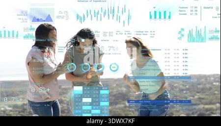 Discussing three women examining phone at overlook, wearing T-shirts and jeans with AR overlays Stock Photo