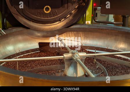 Starbucks Reserve Roastery Milano. Coffee beans cool inside a roasting machine, symbolizing the journey from raw crop to gourmet drink in the global Stock Photo