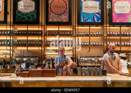 Specialty coffee culture displayed through barista craftsmanship, global bean selection, and contemporary cafe atmosphere. Customers experience artisa Stock Photo