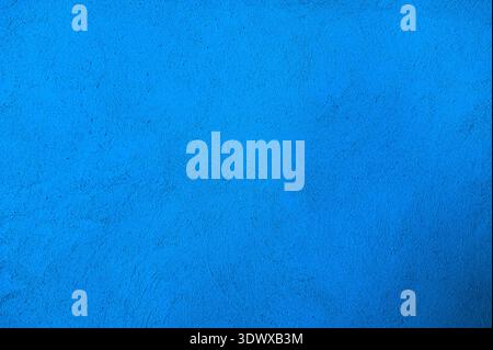 The texture of the plastered white wall with a deep homogeneous structure.rough uniform texture of stucco plaster wall.a fragment of blue plaster. Stock Photo