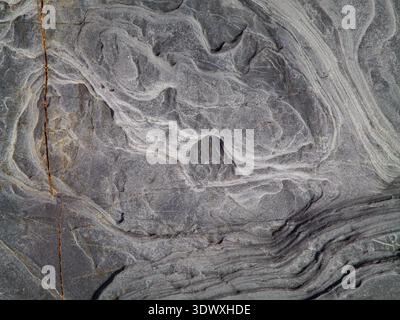 Smooth weathered rock on coastal shoreline Stock Photo
