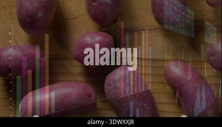 Displaying cluster of red-skinned potatoes resting on wooden cutting board, with holographic charts Stock Photo