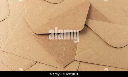 Post kraft paper envelopes background. Brown envelopes pattern in retro style as background with copy space. Stock Photo