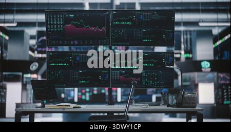 Female Trader Returns Work After Lunch Break With Cup of Coffee in Hand and Takes Seat in Modern Stock Exchange Center. Woman Sits Down at Workstation With Four Monitors Displaying Real time Charts. Stock Photo