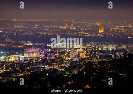 Aerial view of the night city glowing with lights from an airplane ...