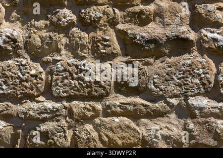 Seamless Texture of Ancient Natural Stone Wall with Weathered Rocks and Mortar, tileable. Stock Photo