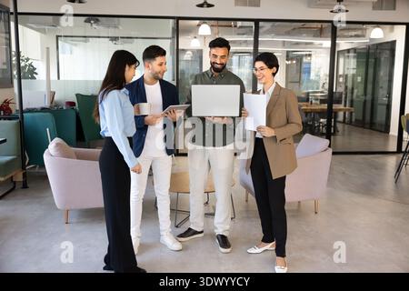 Smiling team members discussing project in office Stock Photo