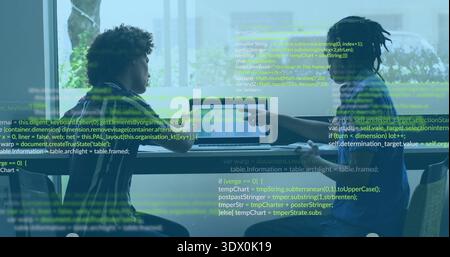 Reviewing code overlay two men collaborating on laptop in glass room, wearing striped, dark shirts Stock Photo
