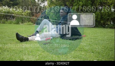 Sitting man leaning on hand in park, jacket as pad, pants-shoes, with binary overlay and red-case Stock Photo