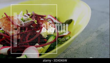 Serving lime bowl on gray countertop with beet salad, radish, feta, shrimp and overlay, copy space Stock Photo
