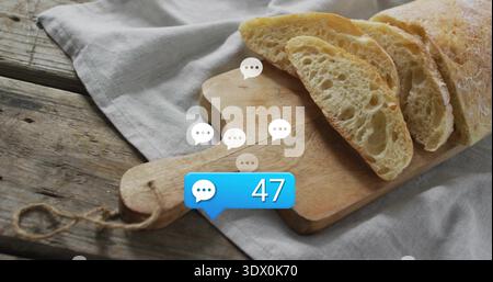 Displaying sliced ciabatta loaf on wooden board with handle and twine, speech bubbles showing 47 Stock Photo
