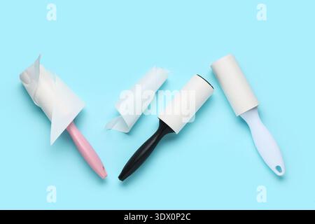 Sticky lint rollers on blue background Stock Photo