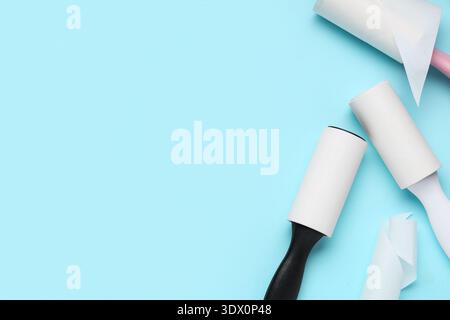 Sticky lint rollers on blue background Stock Photo