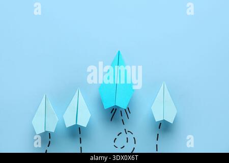 Paper planes with dotted lines on blue background Stock Photo